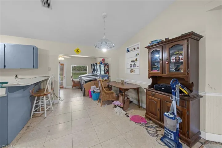 Dining space featuring vaulted ceiling and light tile patterned floors