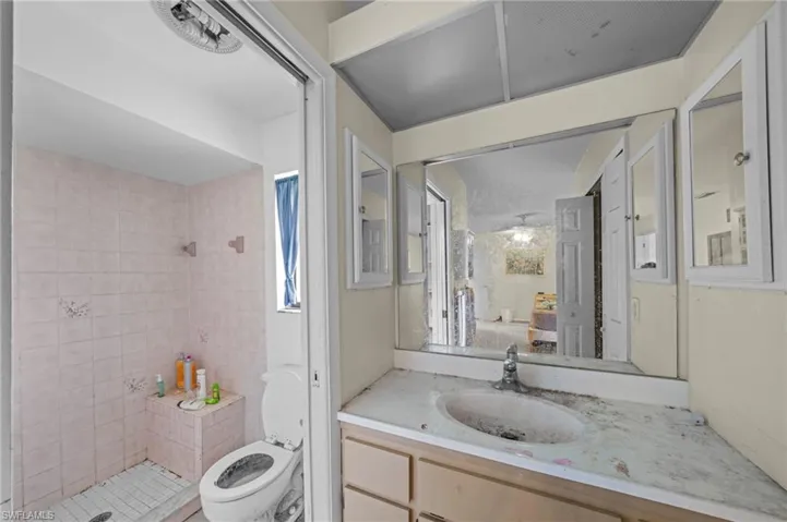 Bathroom featuring a shower stall and vanity