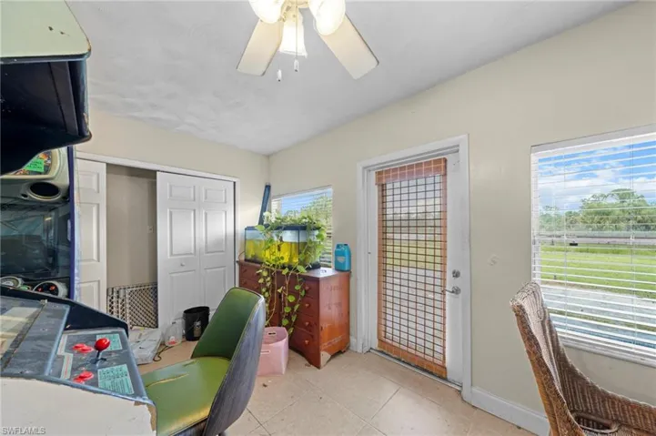 Office space with a ceiling fan and light tile patterned floors