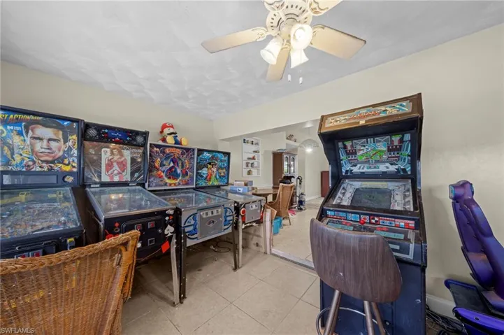 Recreation room with tile patterned flooring and ceiling fan