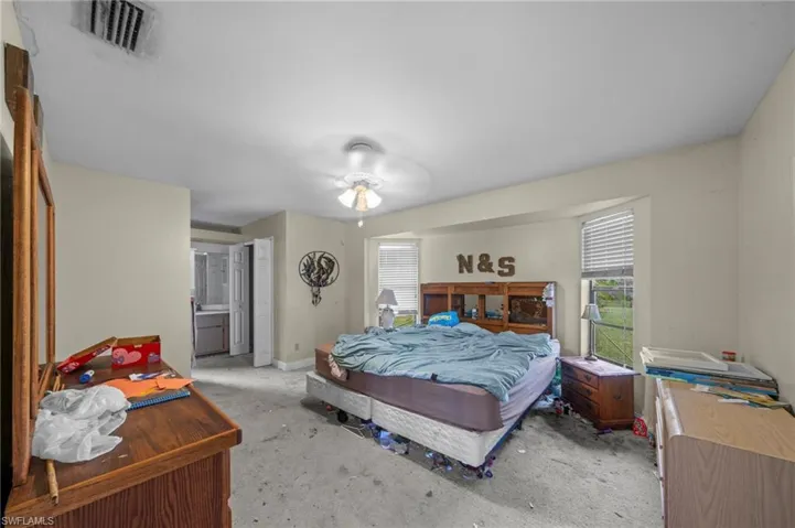 Bedroom featuring light colored carpet and baseboards