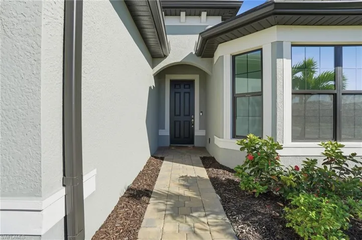 Property entrance featuring stucco siding