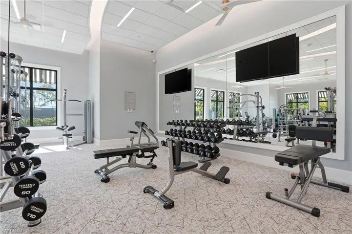 Workout area featuring ceiling fan and a paneled ceiling