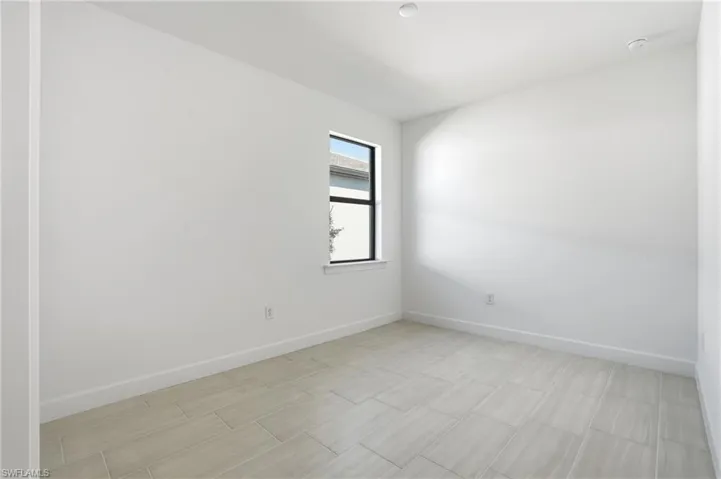 Empty room featuring baseboards