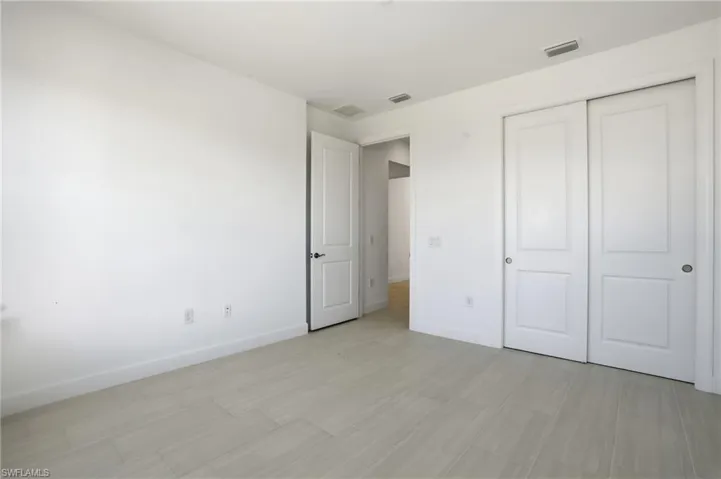 Unfurnished bedroom featuring baseboards and a closet