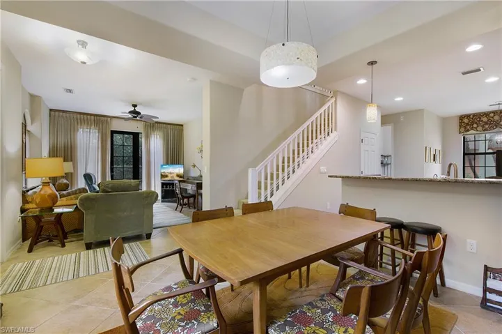 Dining area with stairs, light tile patterned flooring, a ceiling fan, recessed lighting, and baseboards