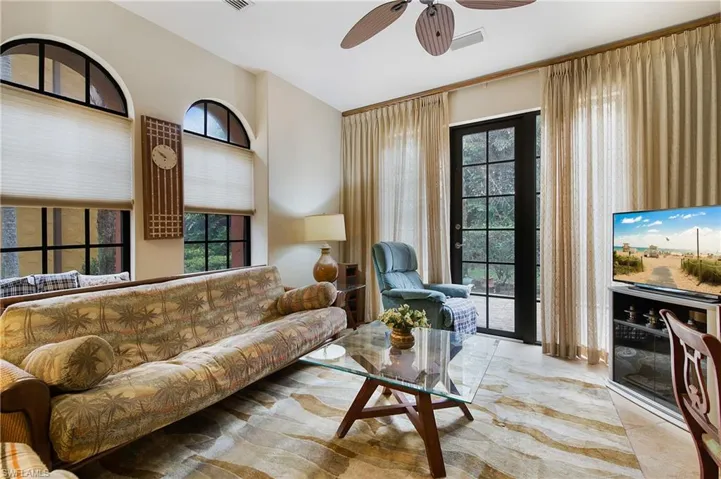 Living room featuring lofted ceiling and a ceiling fan