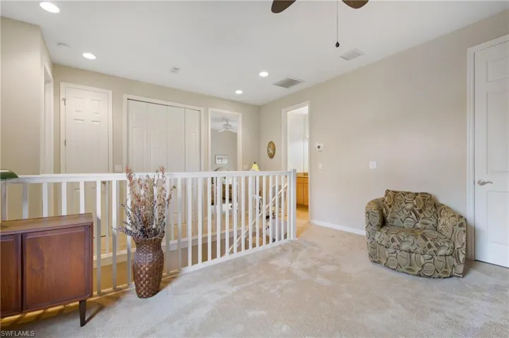 Sitting room with ceiling fan, light colored carpet, an upstairs landing, recessed lighting, and baseboards