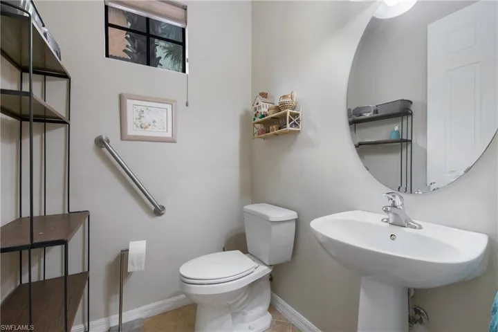 Half bathroom featuring toilet and baseboards