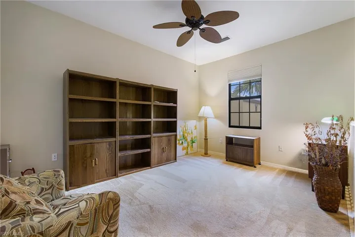 Sitting room with a ceiling fan, carpet flooring, and baseboards