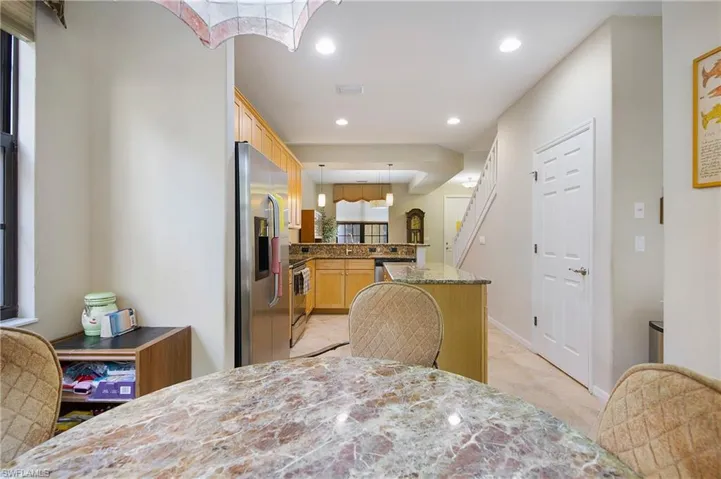 Dining room featuring light tile patterned floors and recessed lighting