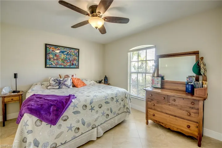 Tiled bedroom with ceiling fan