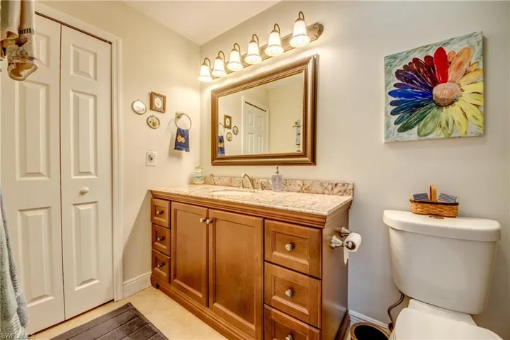 Bathroom with tile patterned flooring, vanity, and toilet
