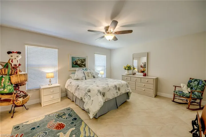 Bedroom featuring light tile patterned floors and ceiling fan