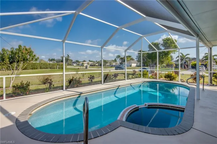 View of swimming pool featuring an in ground hot tub, a lanai, and a patio area