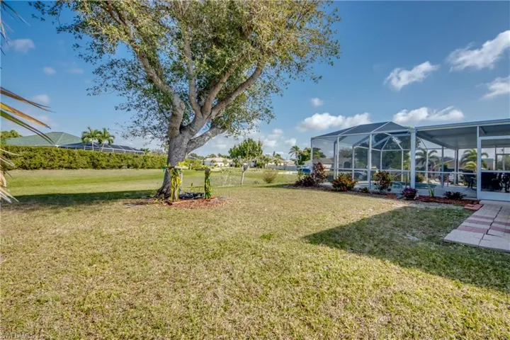 View of yard with glass enclosure