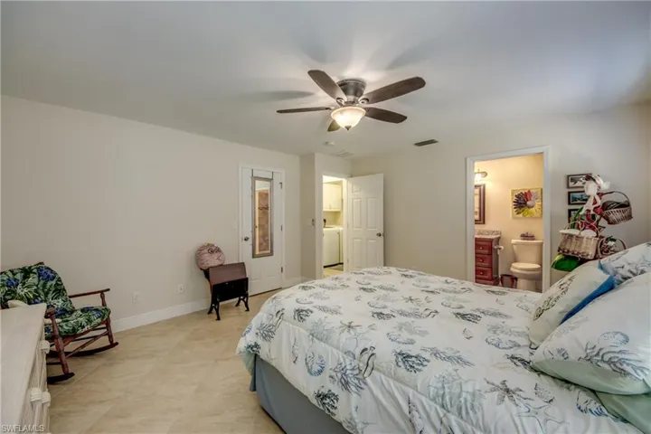Bedroom featuring ceiling fan , en-suite bathroom