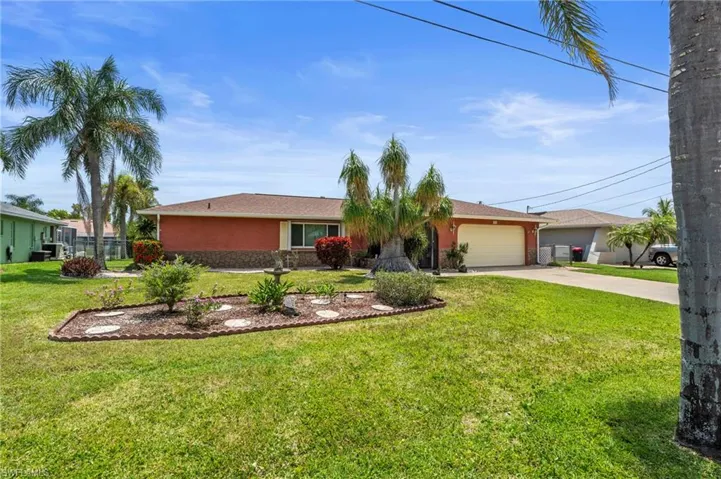 Ranch-style house featuring driveway, an attached garage, and stucco siding  Photo virtually enhanced.