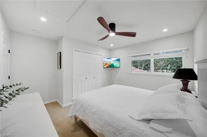 Bedroom featuring carpet, ceiling fan, a closet, and recessed lighting