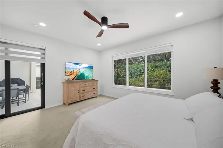Carpeted bedroom featuring ceiling fan, access to exterior, and recessed lighting