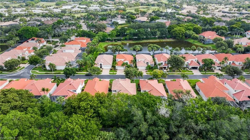 Aerial overview of property's location with a large body of water and nearby suburban area