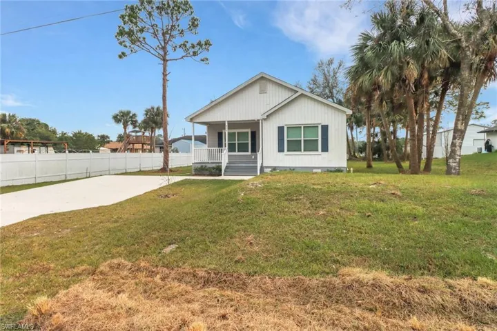 View of front of house featuring a front yard and a porch