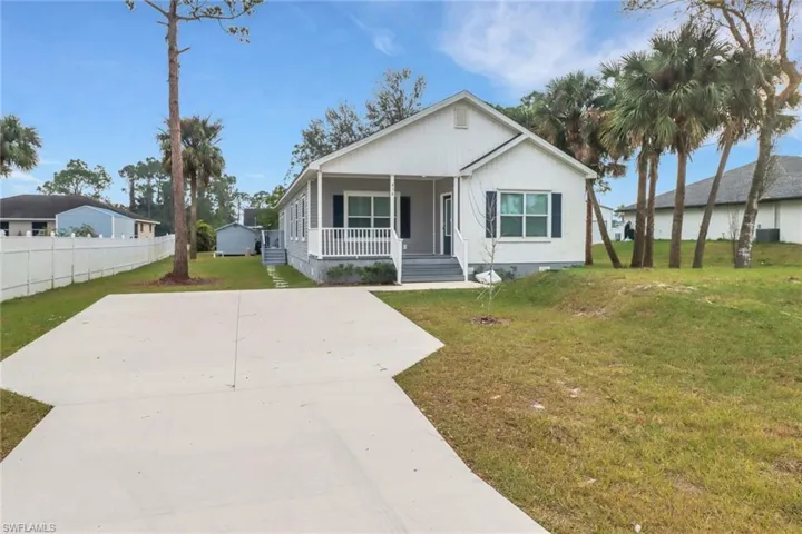 View of front of house with a front lawn and a porch