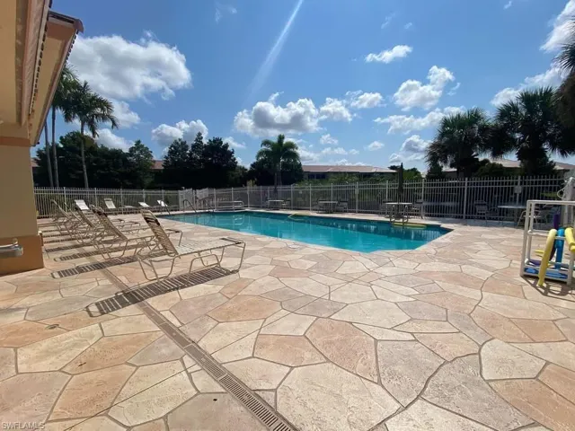 Community pool with a patio