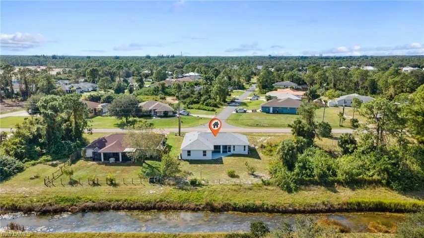 Bird's eye view of a nearby body of water and a tree filled landscape