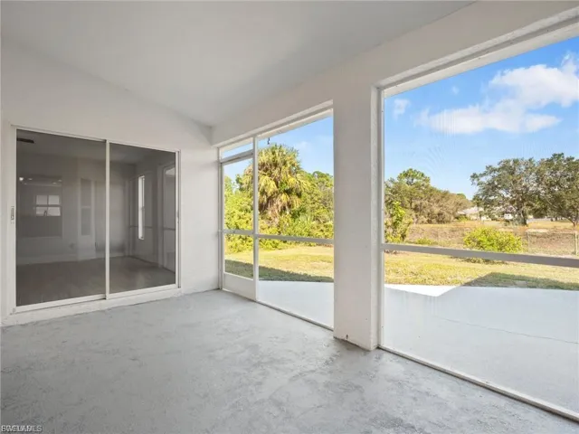 Unfurnished sunroom featuring lofted ceiling