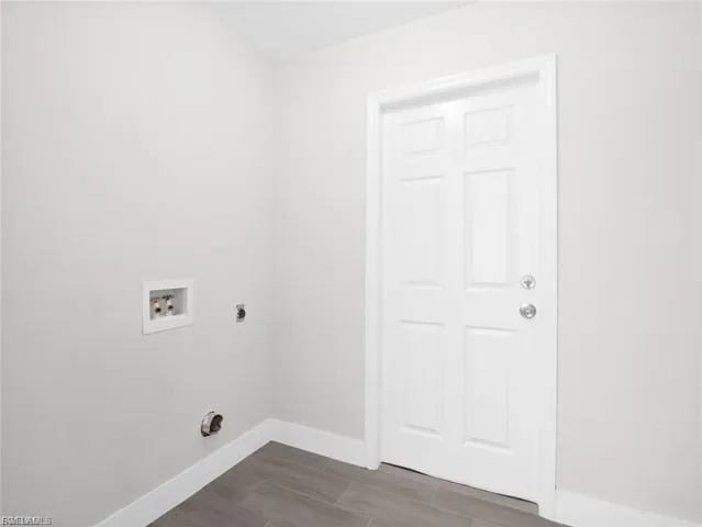 Laundry room featuring hookup for a washing machine, electric dryer hookup, and wood finish floors