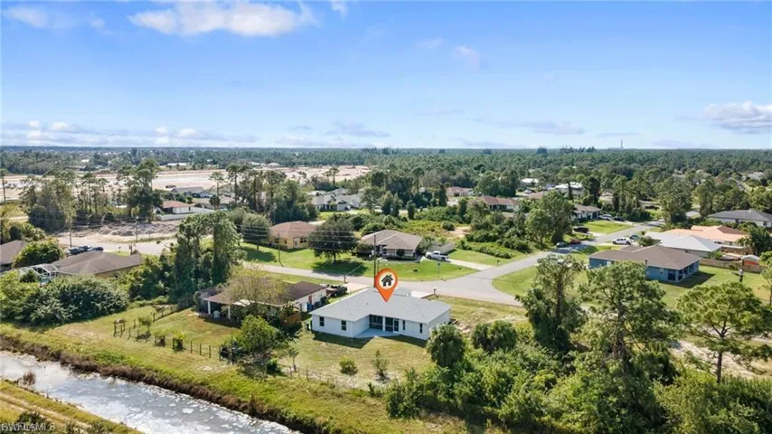 Aerial perspective of suburban area with a nearby body of water