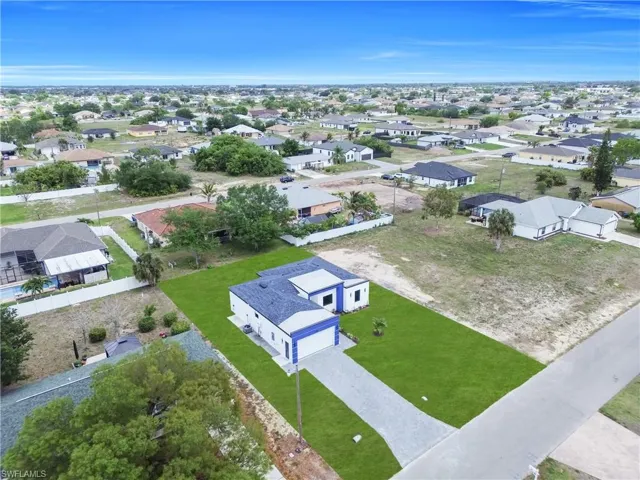 Contemporary single-story residence featuring a dark blue hip roof and white exterior