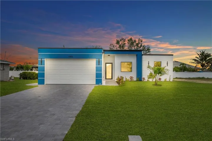 Contemporary exterior with a white facade and blue architectural accents
