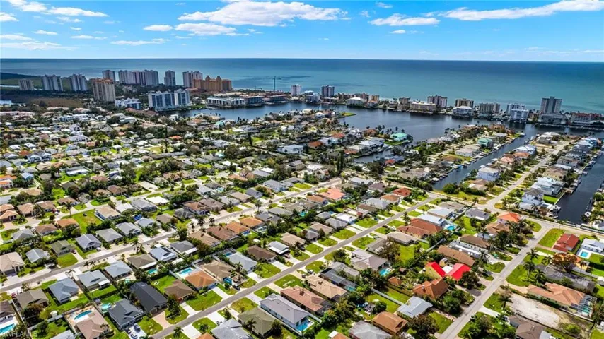 Birds eye view of property featuring a city view and a water view