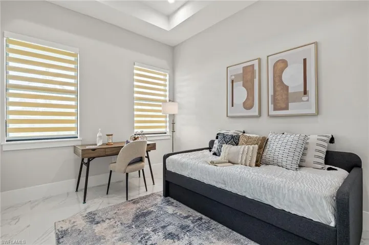 Bedroom with baseboards and marble finish floor