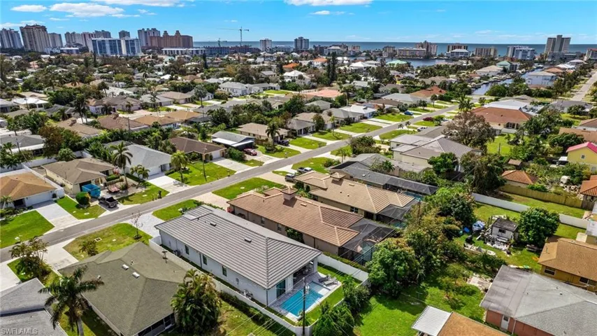 Drone / aerial view featuring a residential view, a water view, and a view of city