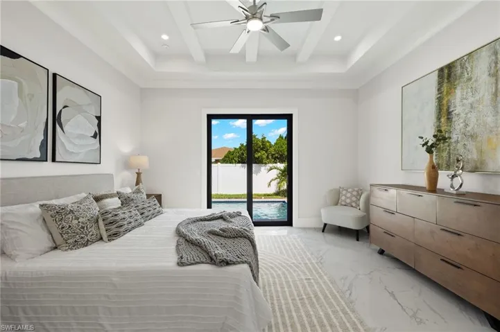 Bedroom featuring recessed lighting, beamed ceiling, a ceiling fan, marble finish floor, and access to outside