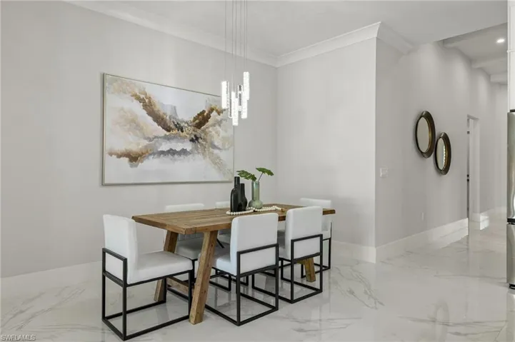 Dining area featuring baseboards, marble finish floor, recessed lighting, and crown molding