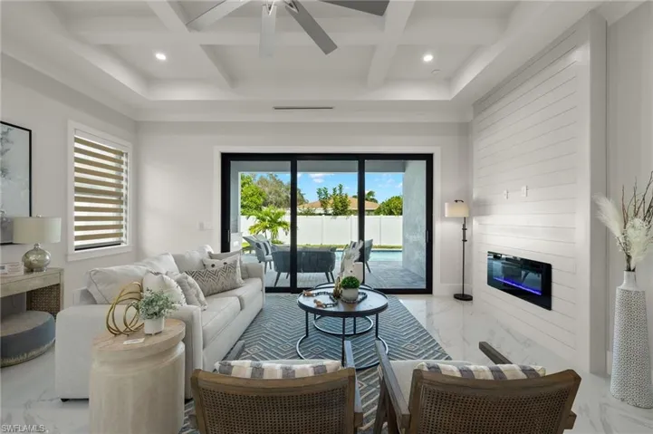 Living room featuring recessed lighting, marble finish floor, a large fireplace, and ceiling fan