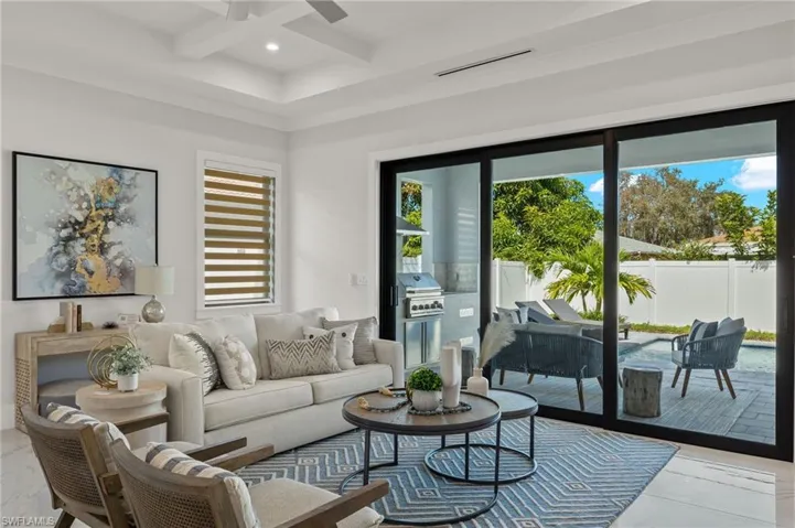 Living area with recessed lighting, coffered ceiling, visible vents, a ceiling fan, and beam ceiling