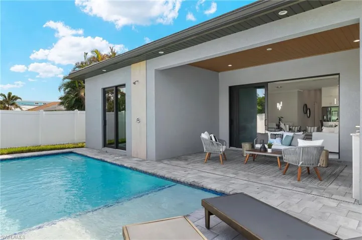 View of pool with fence, a patio area, a fenced in pool, and an outdoor living space