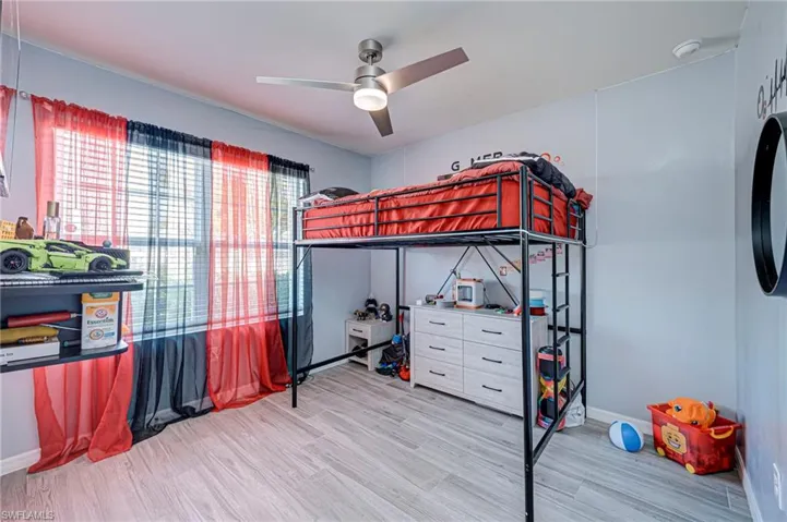 Bedroom with light wood-style floors and ceiling fan