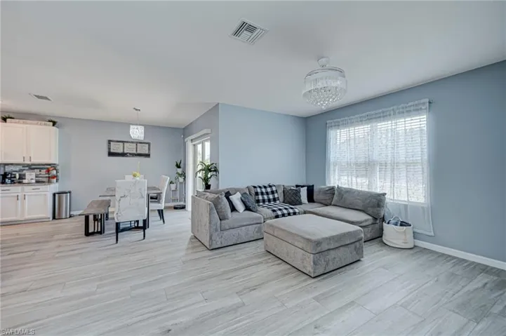 Living room with light wood-style flooring