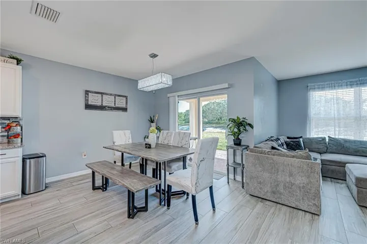 Dining area featuring wood tiled floors and baseboards