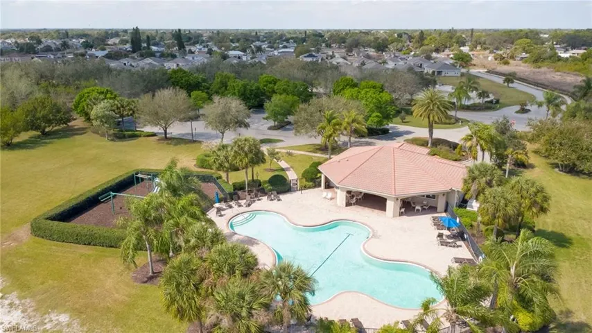 Community pool with a patio and a yard