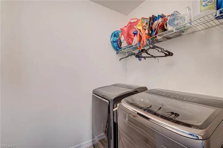 Laundry room featuring separate washer and dryer and baseboards