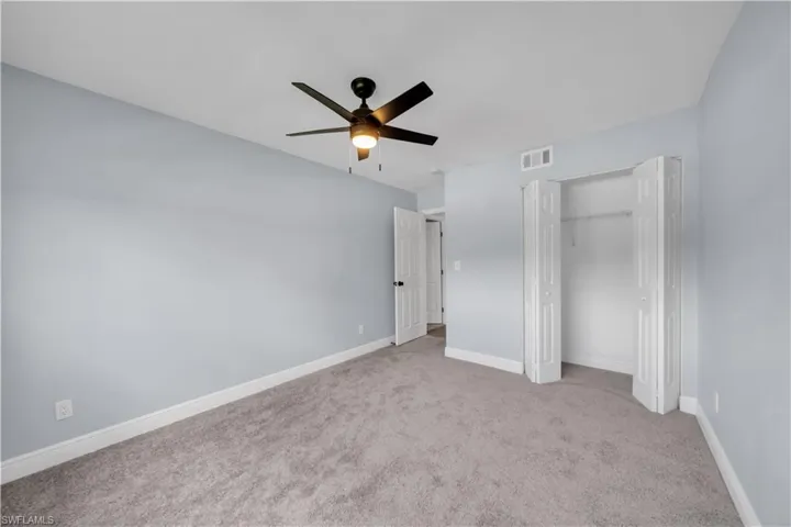 Carpeted room with light blue walls and white trim