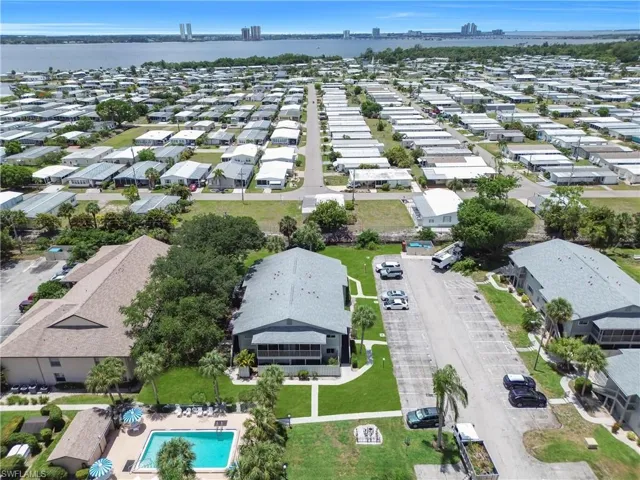 Aerial perspective featuring a residential community with numerous single-story properties and multi-unit buildings
