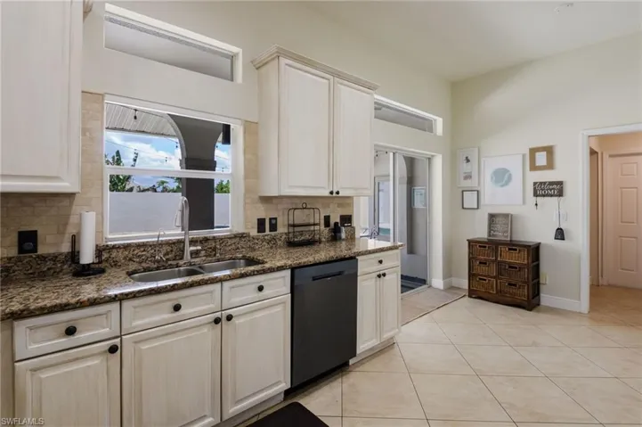 The kitchen has direct access to the courtyard pool area through the sliding glass doors.